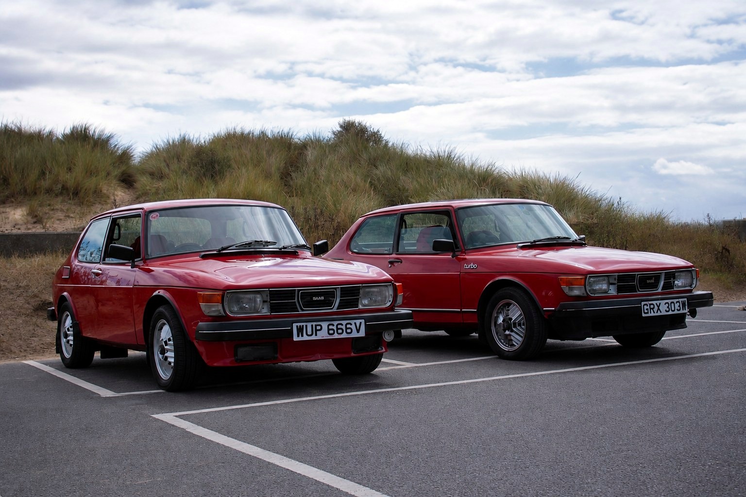 Two Saab 99 Turbos by the dunes